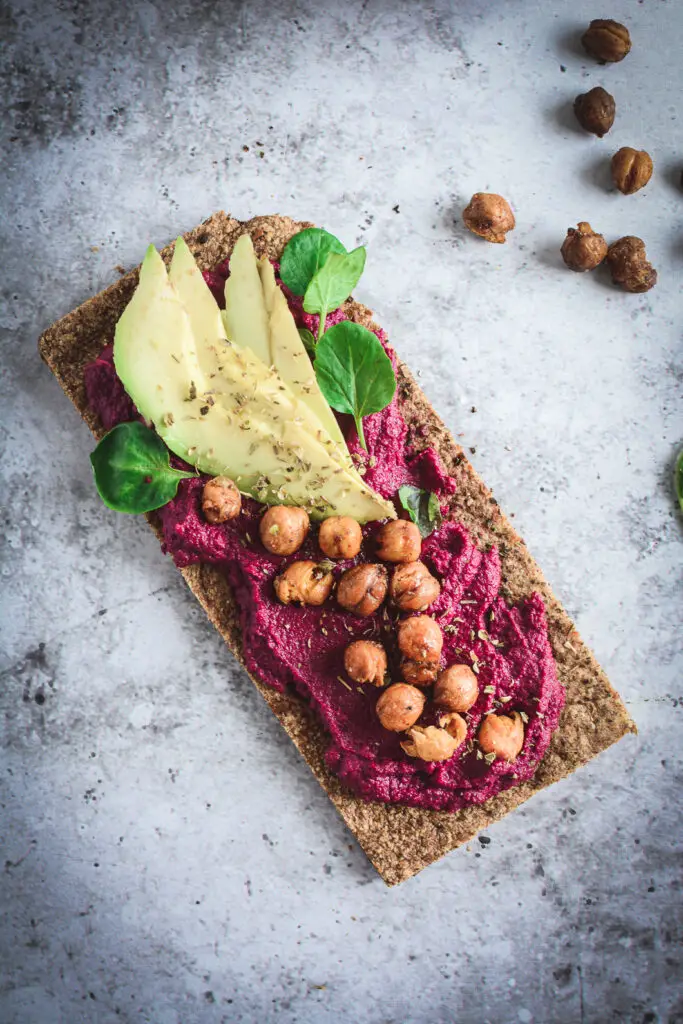 Beet Hummus on paleo flat bread topped with crispy chickpeas