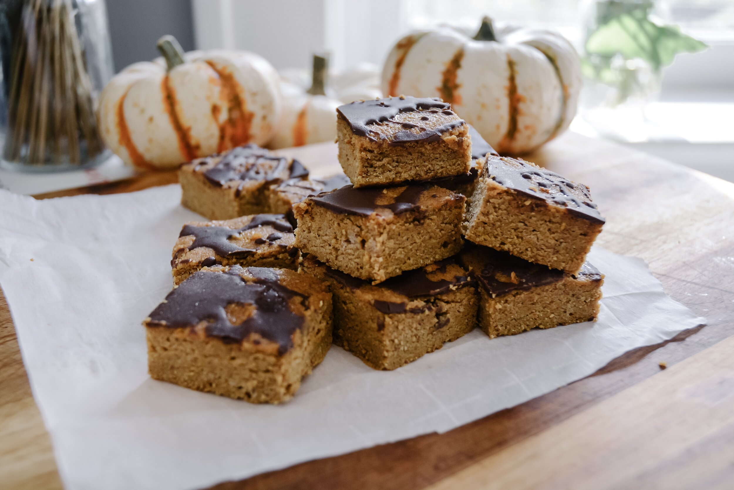  pumpkin bars on table with little pumpkins 