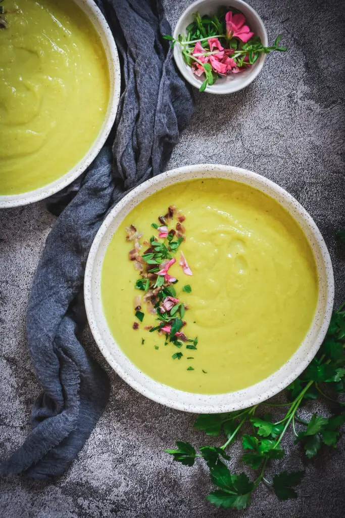 cauliflower soup on table with napkin and parsley