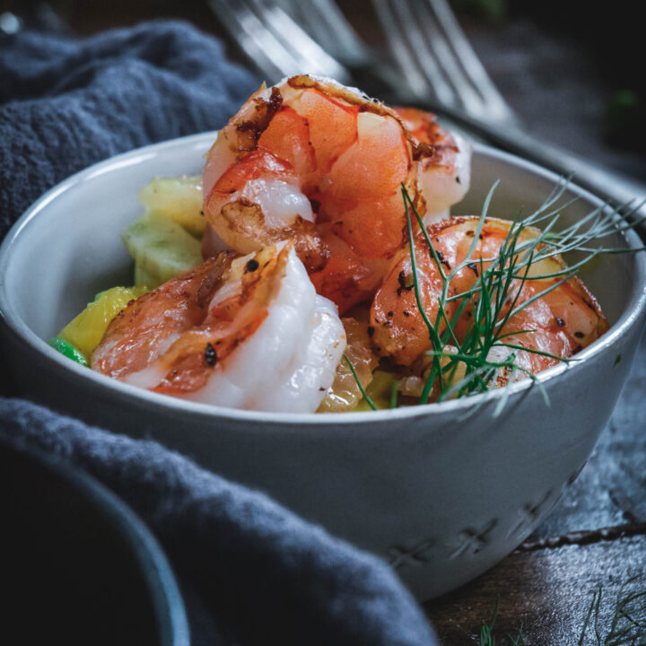 Shrimp and citrus in small small bowl with fennel leaves