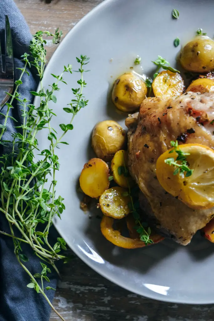 Roasted chicken thighs on top of baby potatoes 