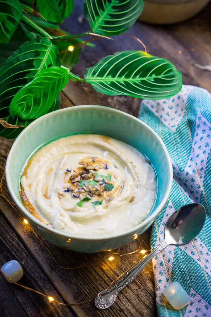 Creamy sunflower soup in bowl with spoon