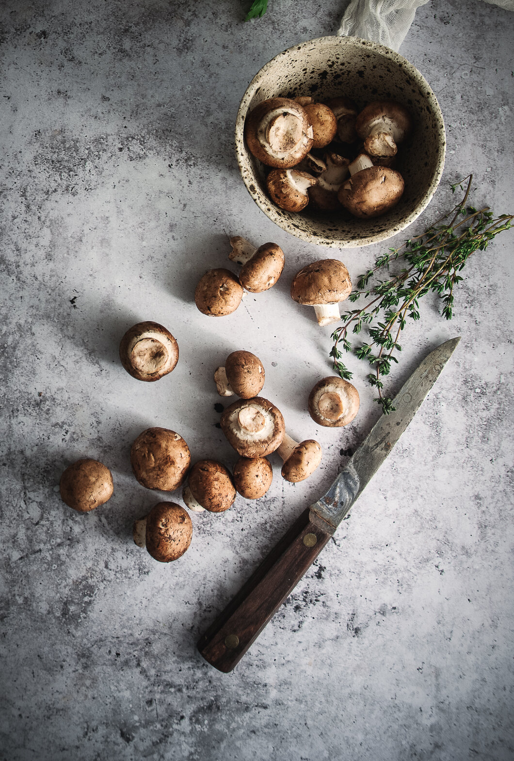 Mushrooms with knife, thyme and bowl