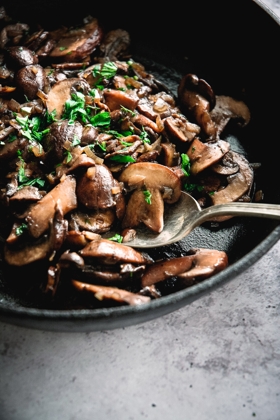 Sautéed mushrooms in pan with spoon