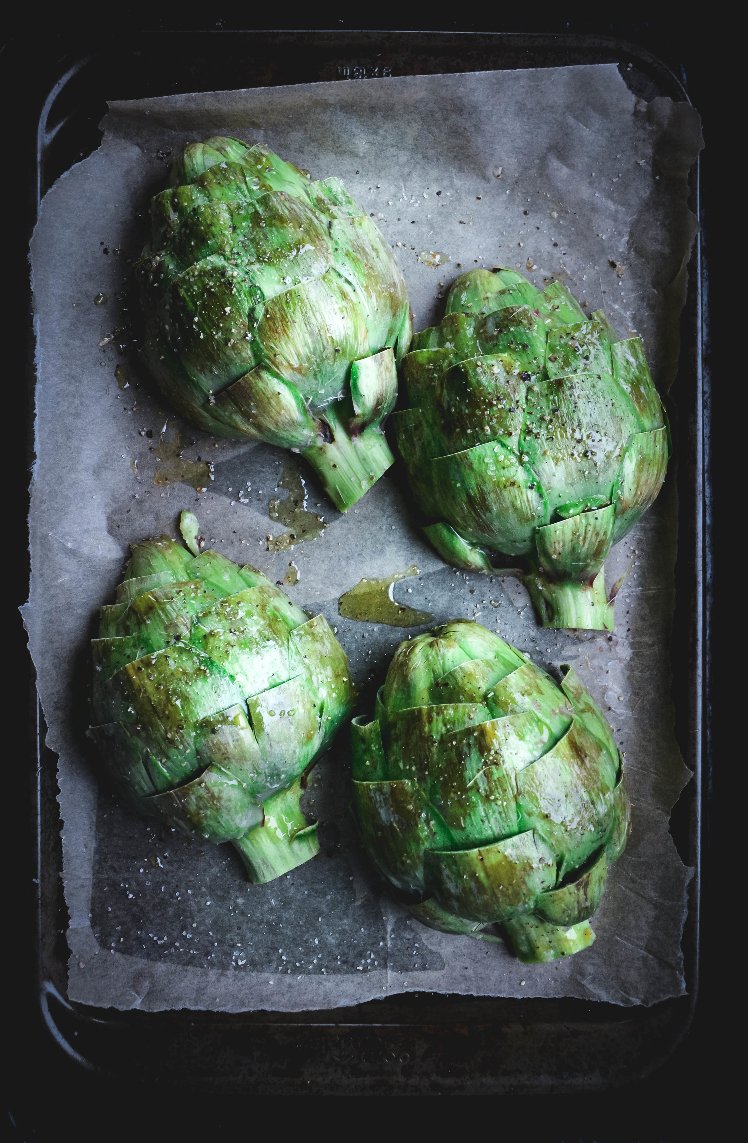 4 artichoke halves on roasting tray