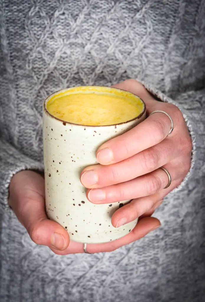 turmeric milk in hands