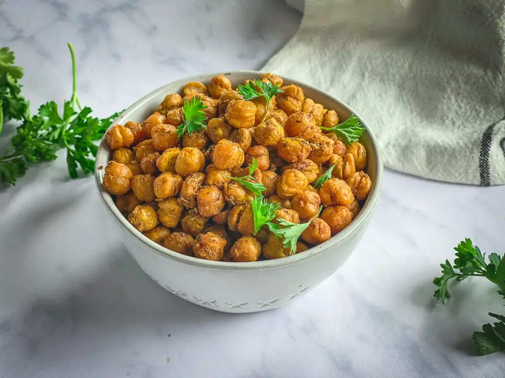 Crispy roasted chickpeas in bowl with parsley 