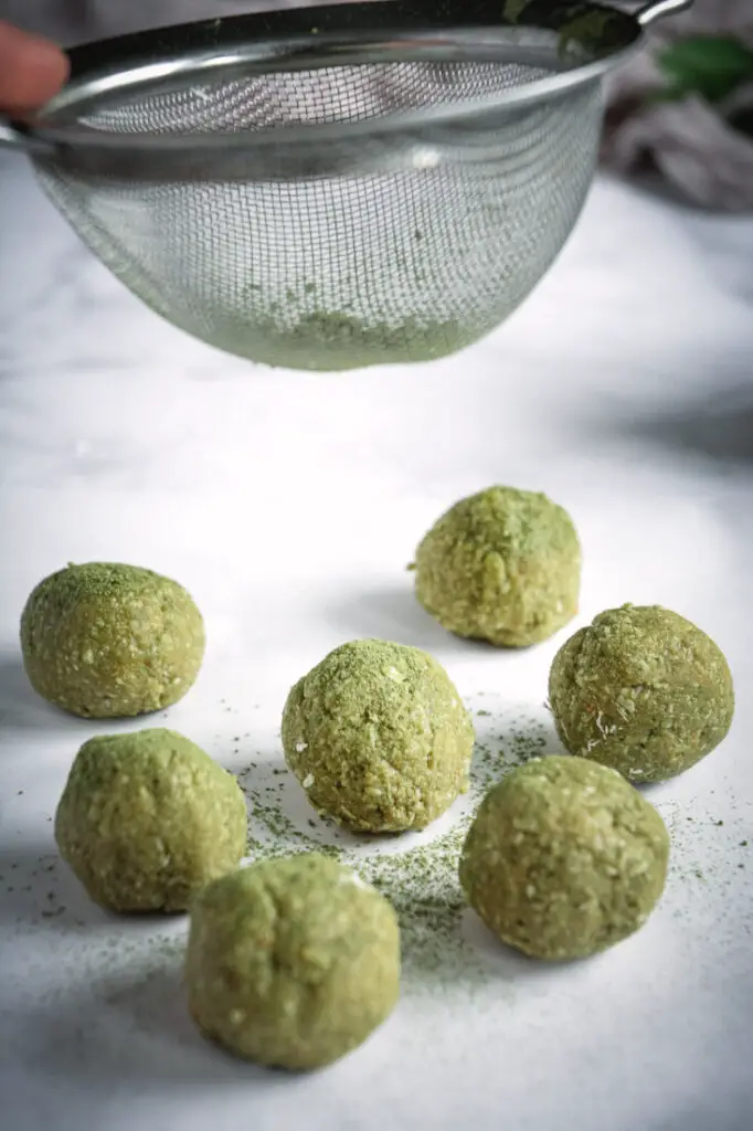 Coconut Cashew Matcha Energy Bites with sifter