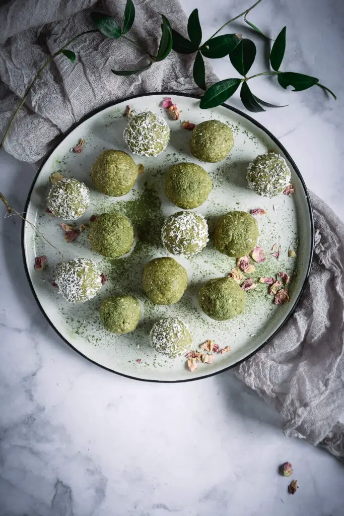 Coconut Cashew Matcha Honey Energy Bites on plate