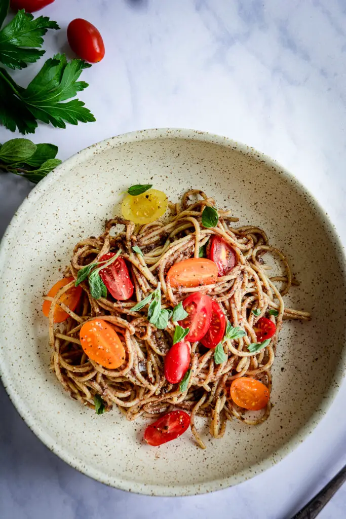 Moroccan Tapenade Spaghetti with Tomatoes and Herbs in bowl