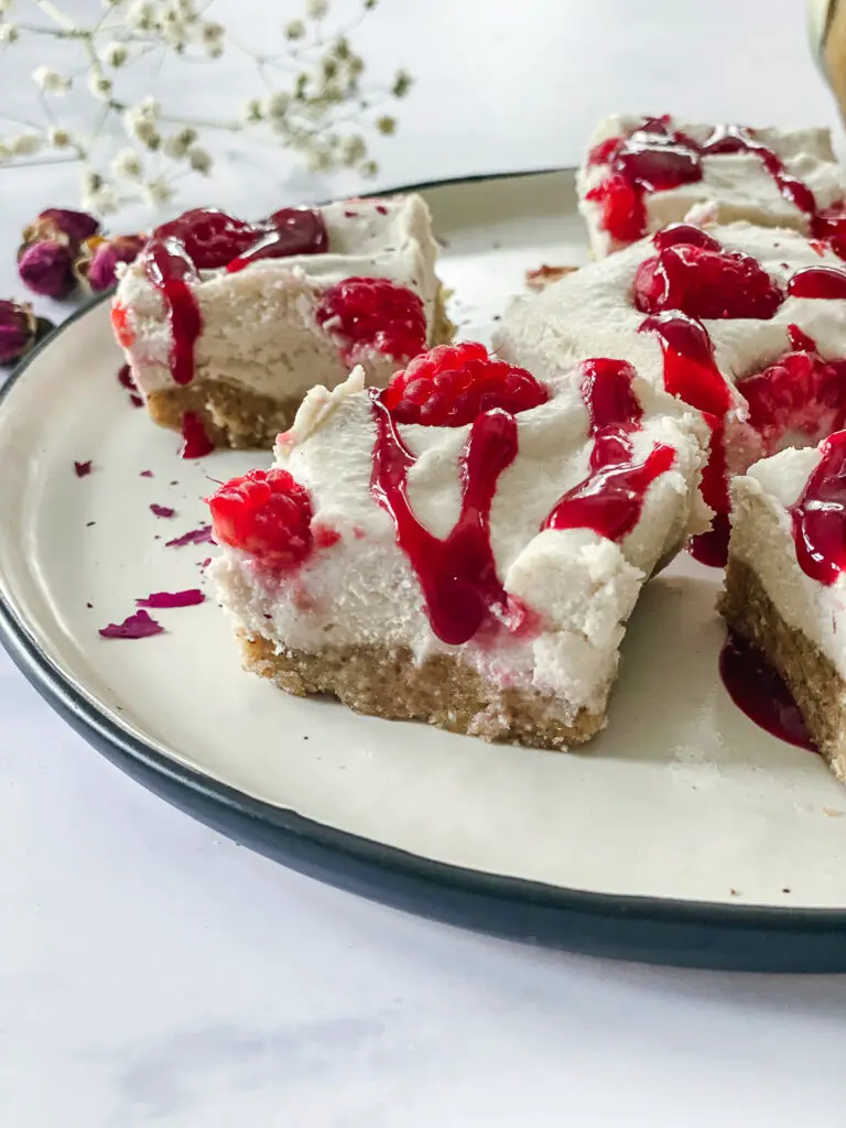 Vegan Raspberry Cheesecake Bites with Rose Cardamom Honey on plate 