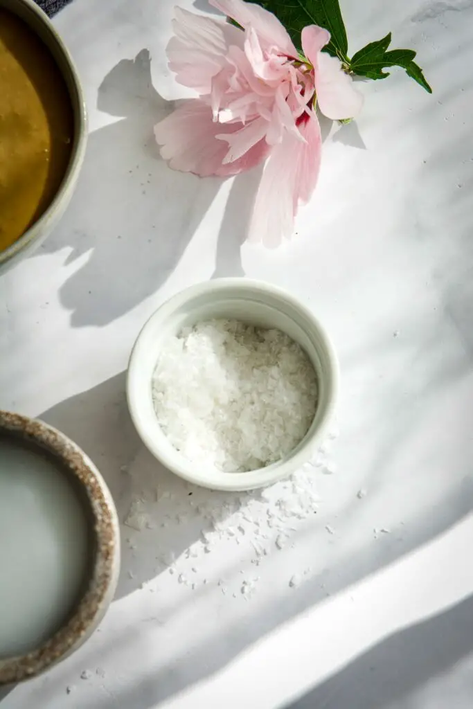 Small bowl of salt, a hibiscus flower on the table