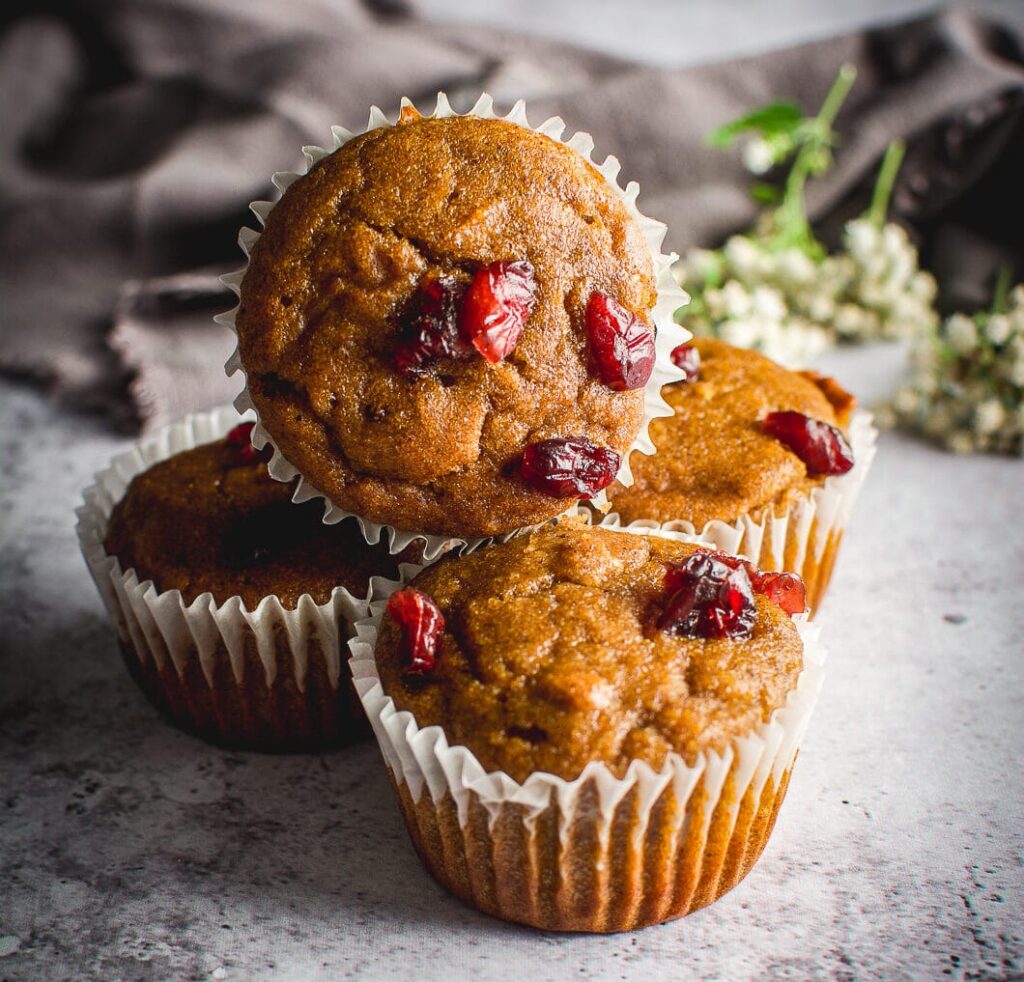 Healthy Grain-Free Cranberry Pumpkin Spice Muffins  on table 