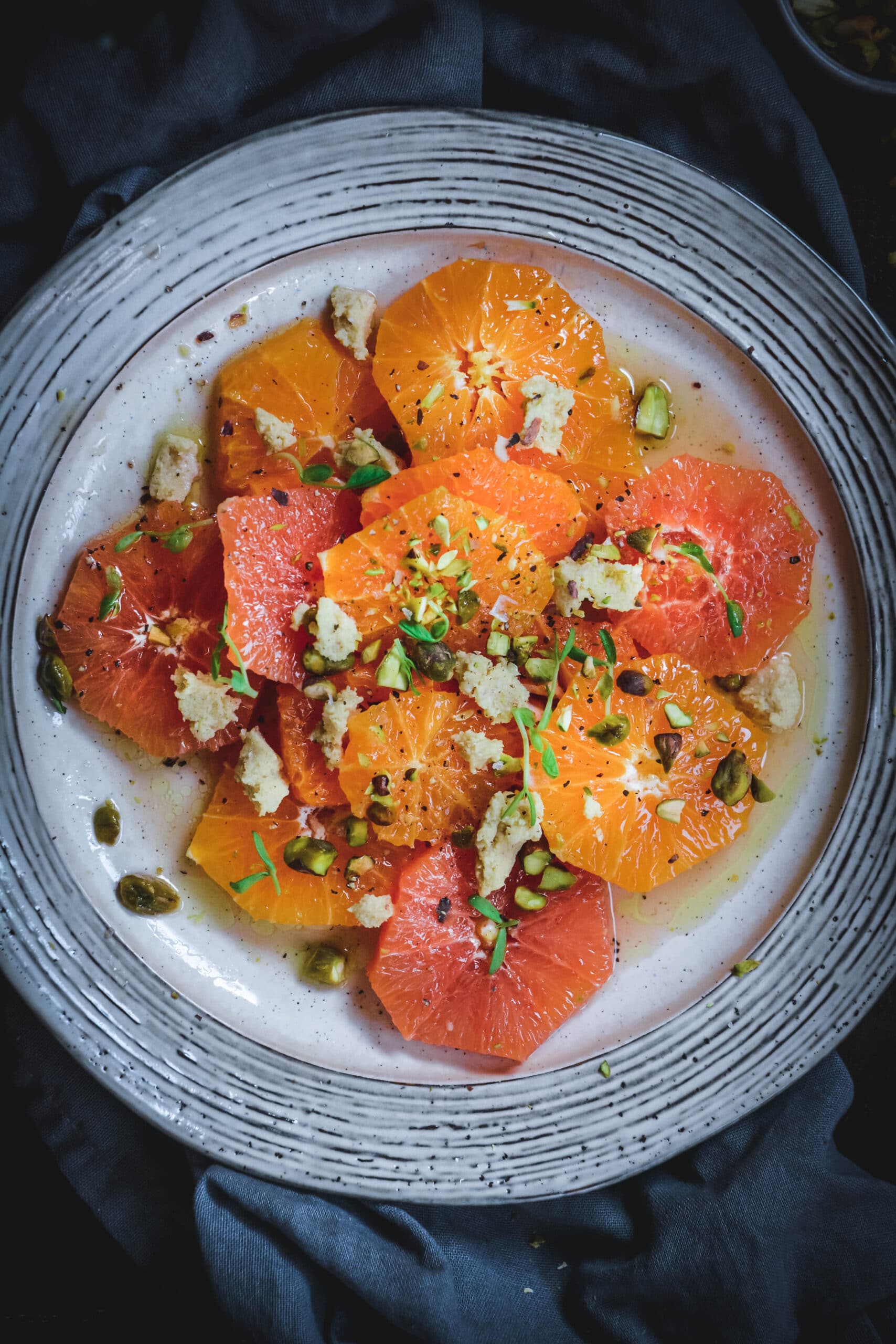 citrus slices on a plate topped with seeds