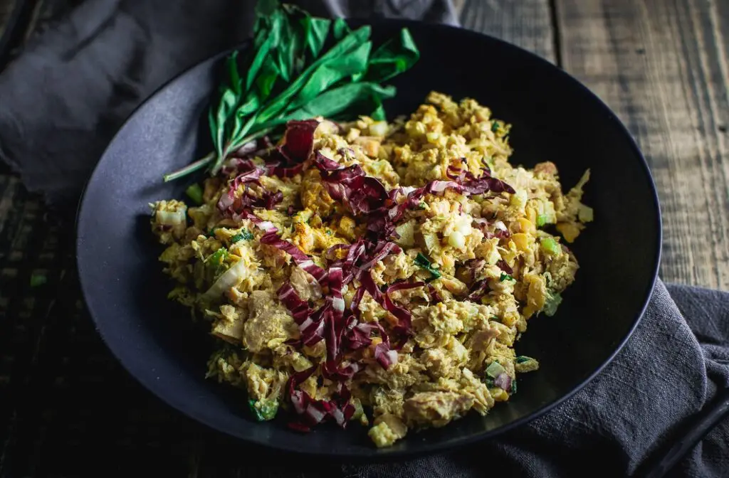Quick Curried Tuna and Chickpea Salad with Tarragon in black bowl on napkin