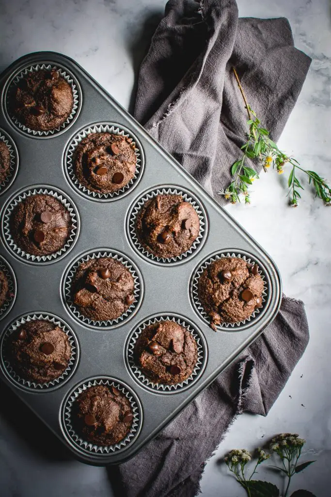 Grain Free Double Chocolate Muffins in muffin tin with napkin