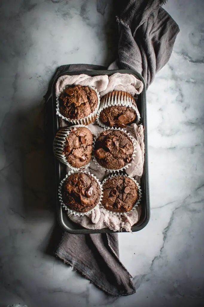 Grain Free Double Chocolate Muffin on tray with napkin on marble board