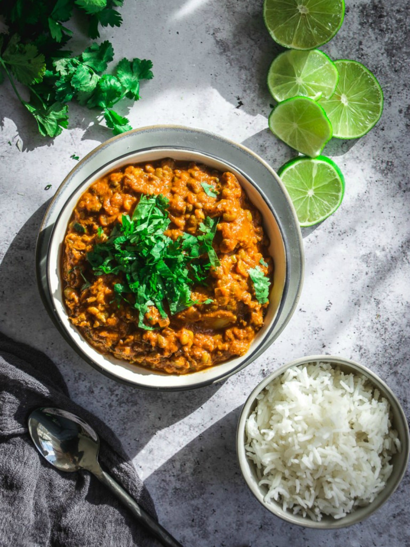 Easy and Healthy Vegan Cauliflower Mung Bean Curry on table with lime slices