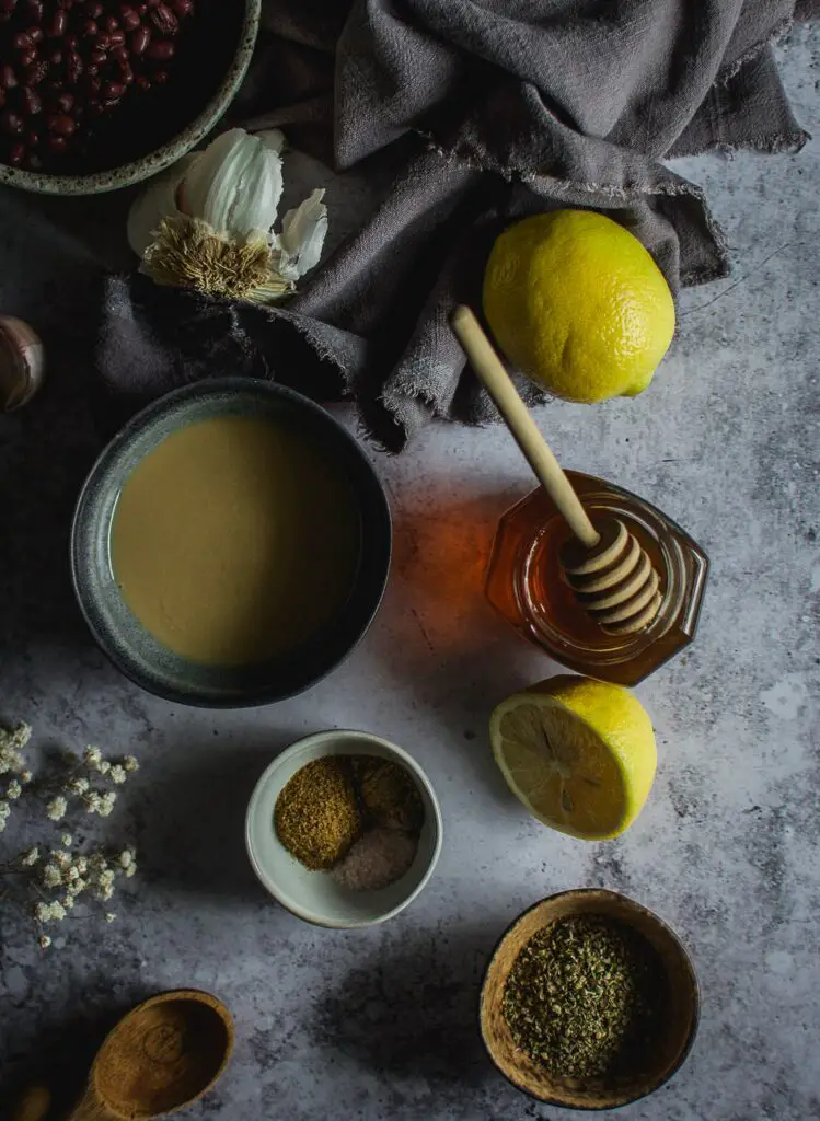 lemons, garlic, tahini, adzuki beans in bowl, honey in jar