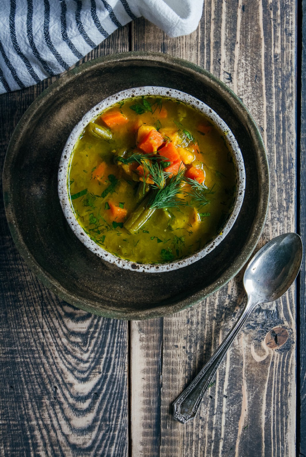 Bone Broth Vegetable Soup in bowl, on wooden table