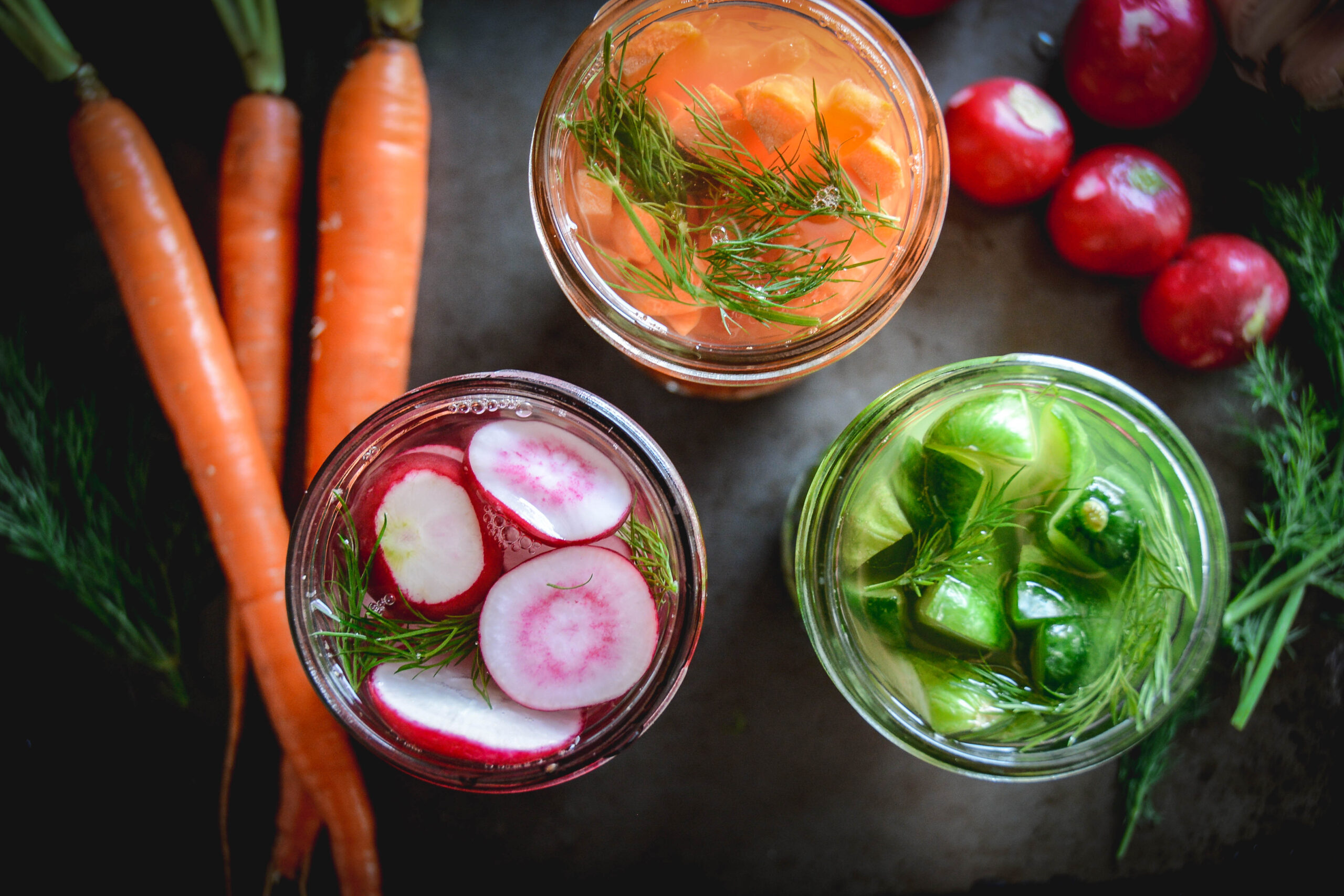 Easy Fermented Vegetables in jars with radishes, cucumbers and carrots and dill
