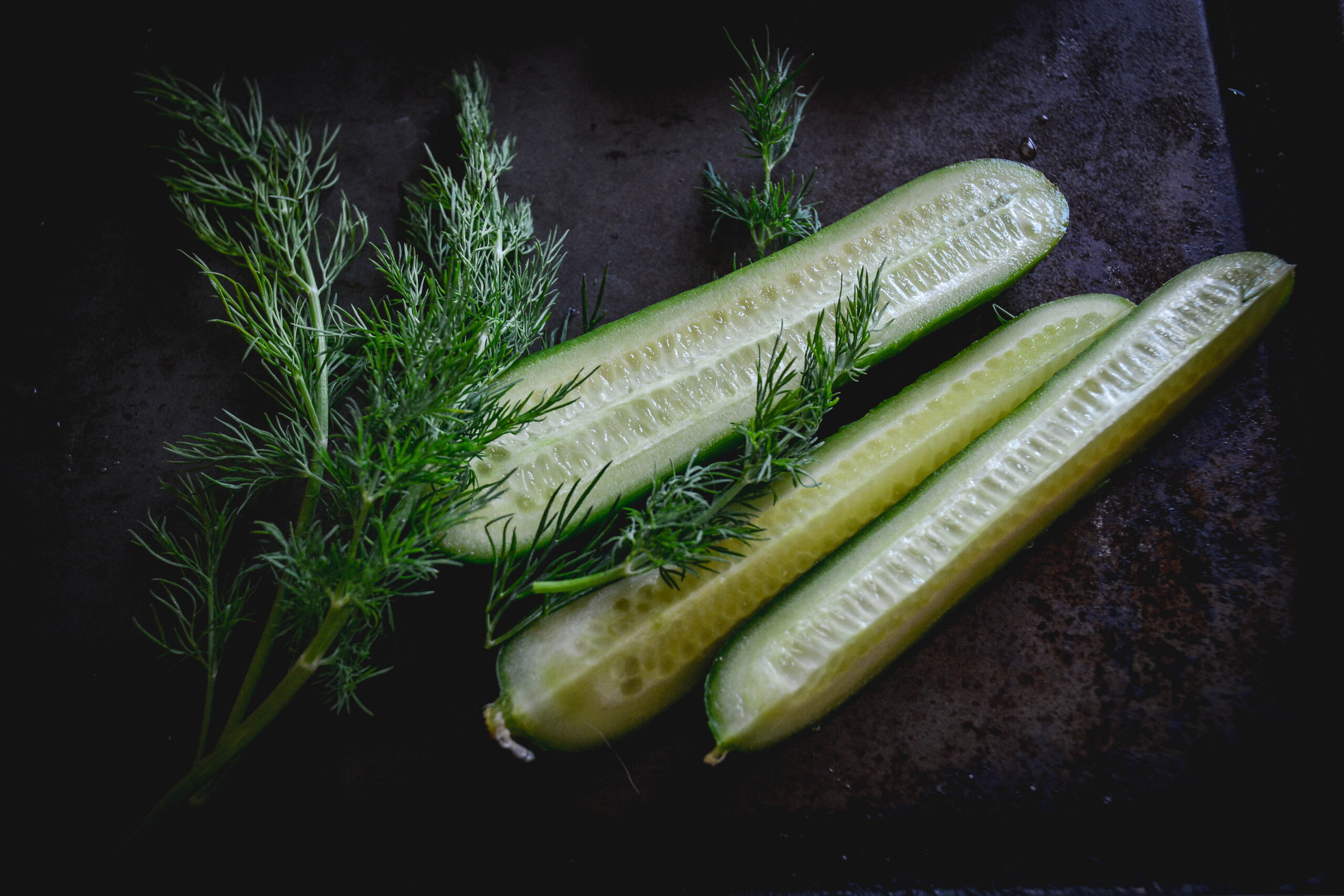 Cucumbers on tray with dill