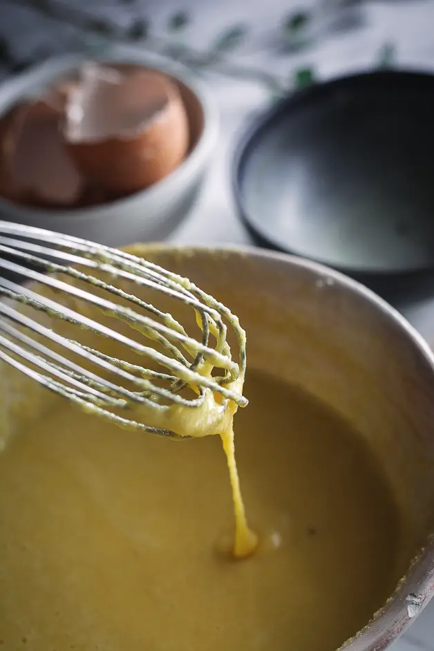 crepe batter in bowl with whisk