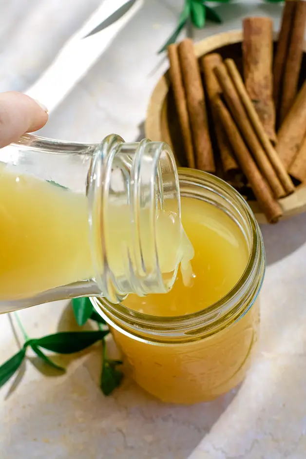 apple cider vinegar being poured from a bottle