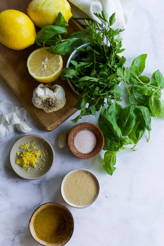 ingredients for green tahini sauce on a table