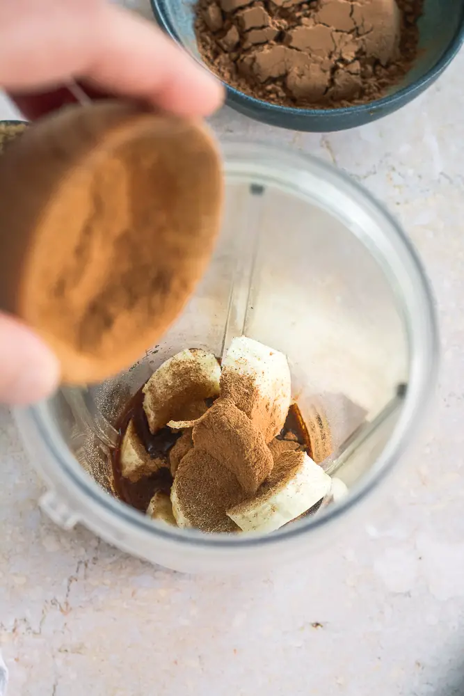 bananas in a blender covered with cinnamon