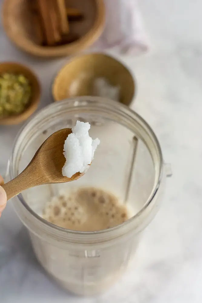 coconut oil being added to a blender
