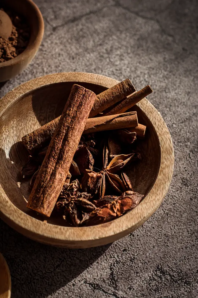 star anise and cinnamon sticks in a bowl