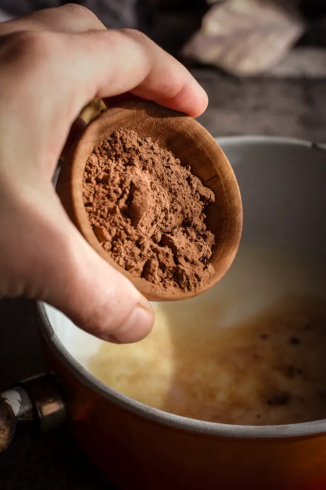 brown powder being added to the pan