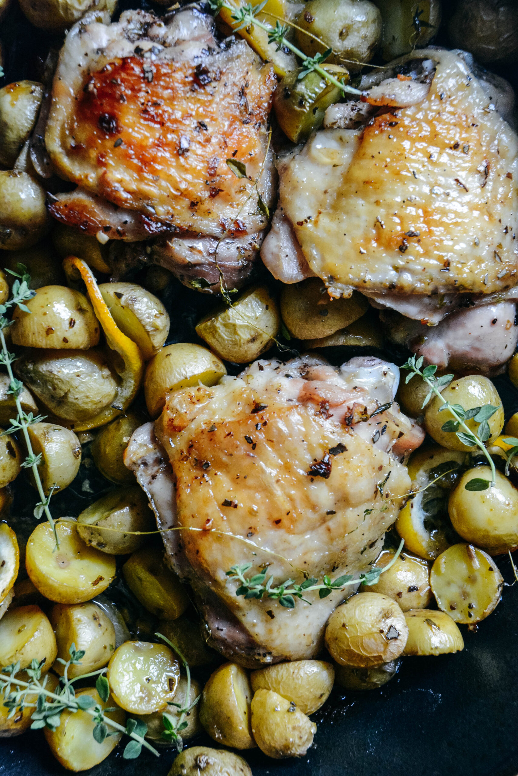 Roasted chicken thighs on top of baby potatoes 