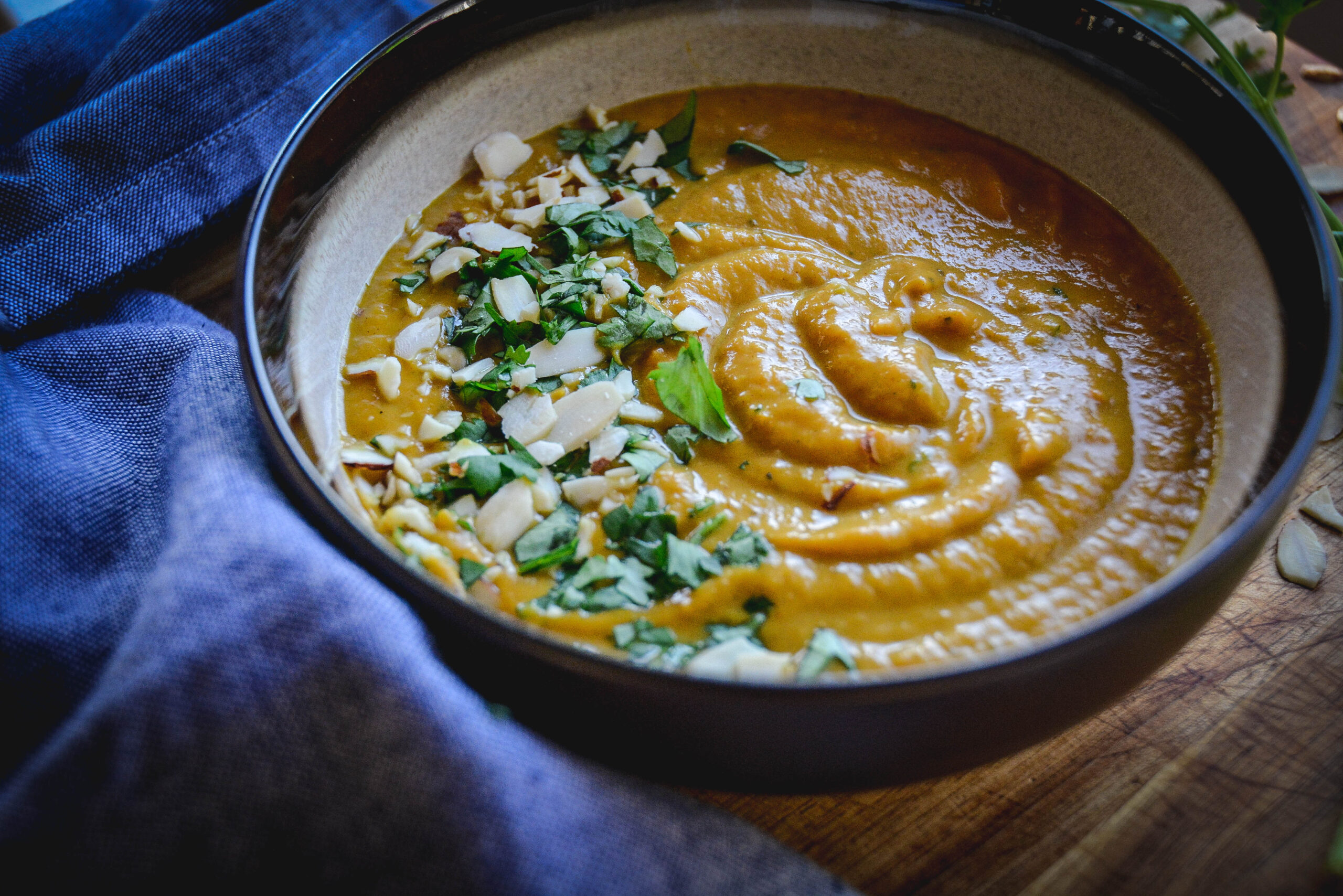 creamy sweet potato soup topped with sliced almonds