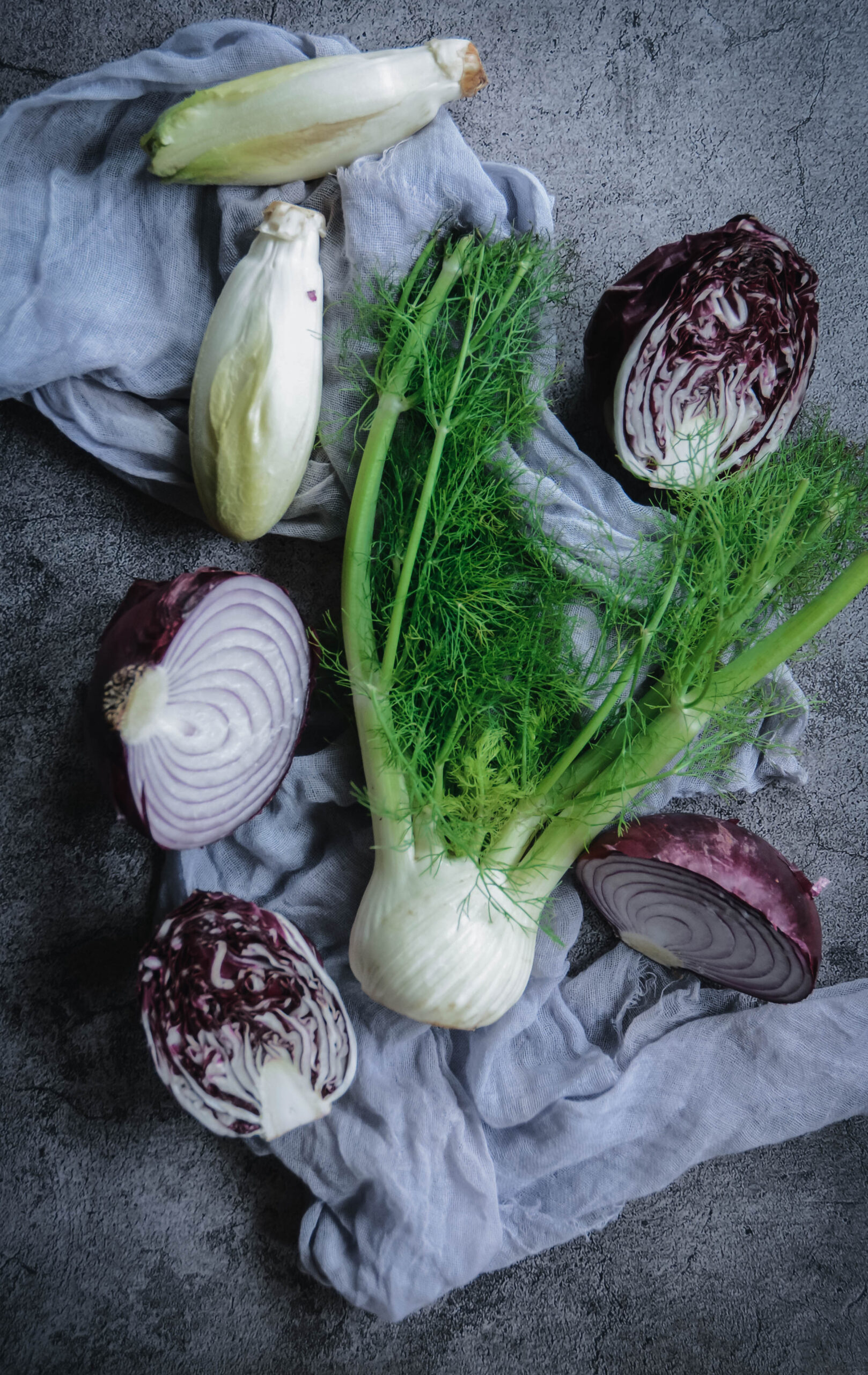 red onion, red lettuce, fennel on a napkin