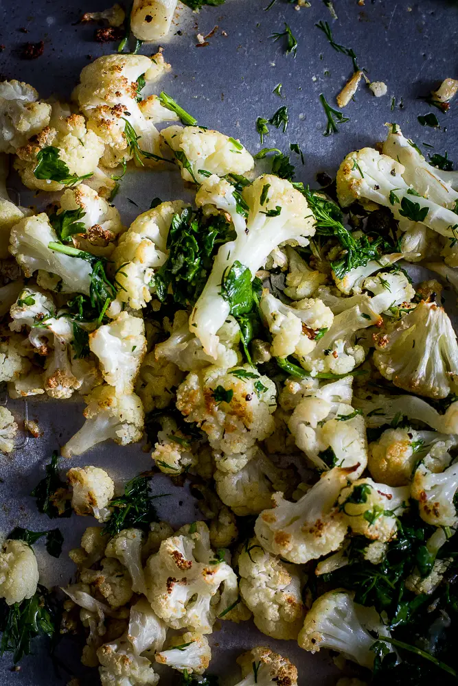 roasted cauliflower with herbs on a roasting tray