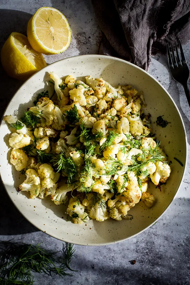 roasted cauliflower with fresh herbs on a plate