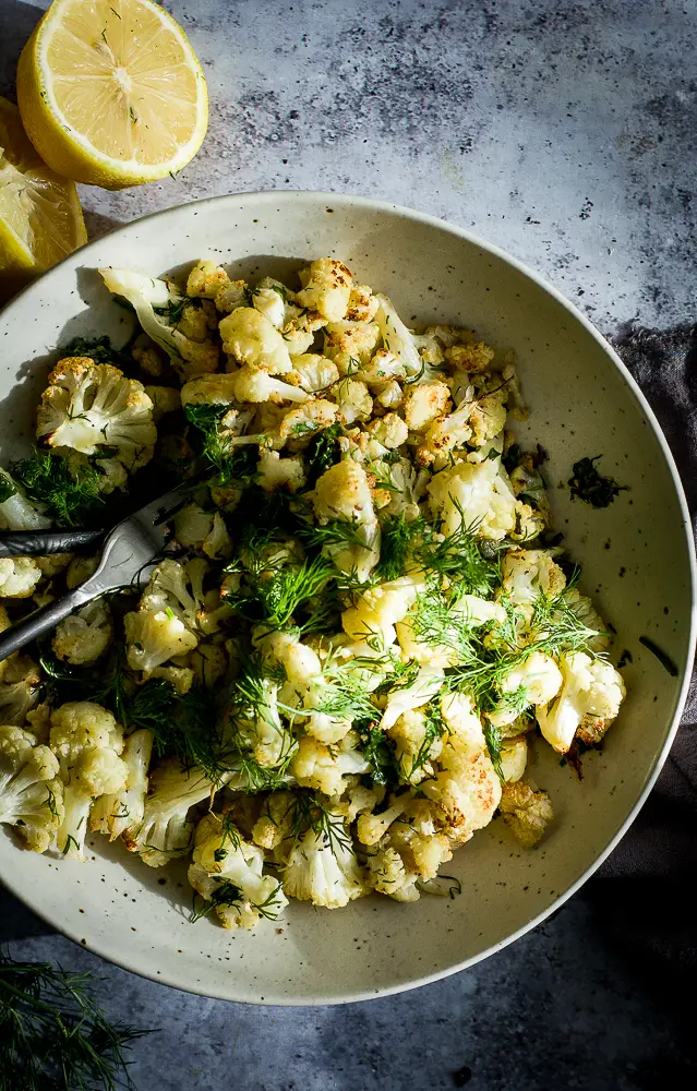 roasted cauliflower with fresh herbs on a plate