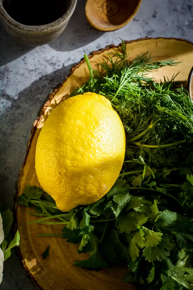 lemon with herbs on a cutting board