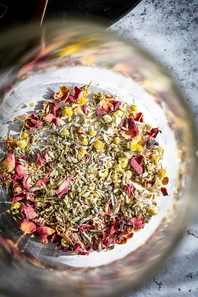 mixed herbs in a glass carafe